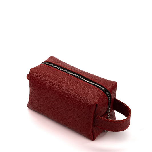 Red leather bag with a zipper on a white background