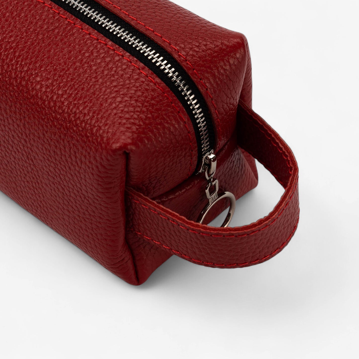 Red leather pouch with a zipper on a white background