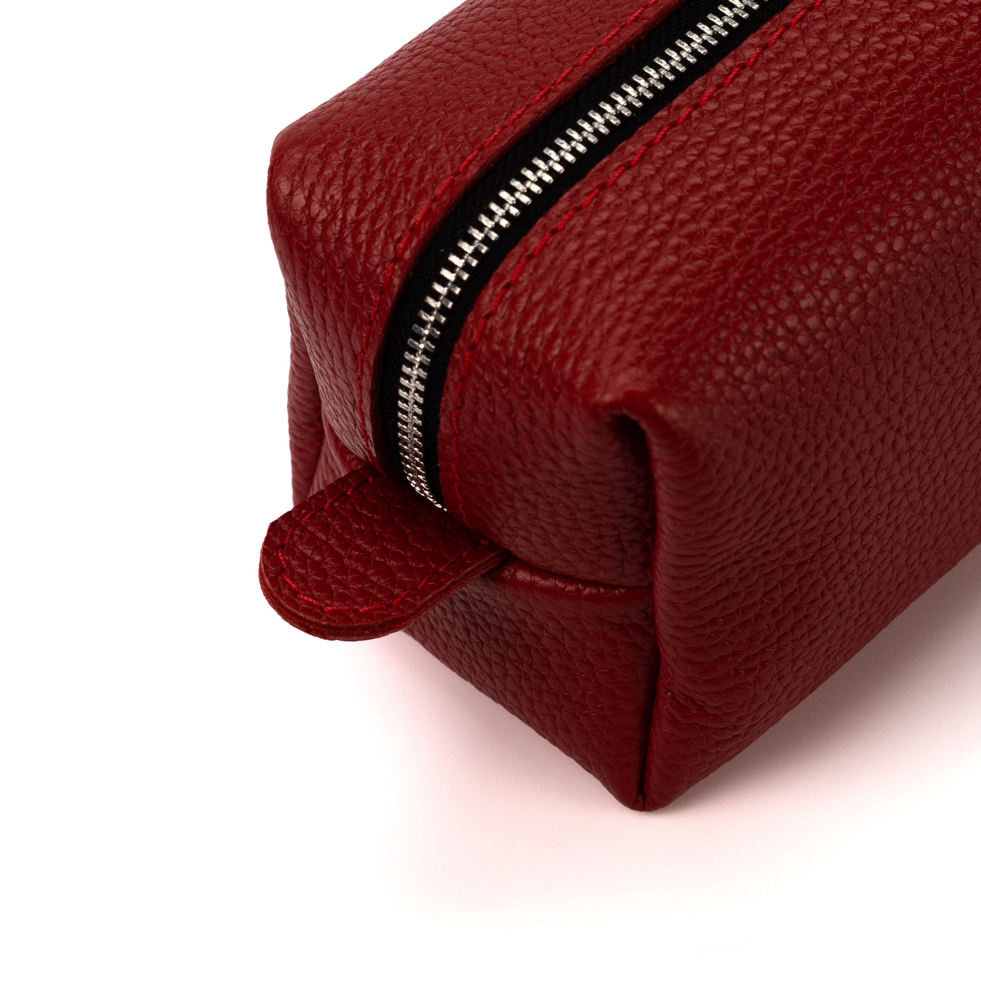 Red leather pouch with a zipper on a white background