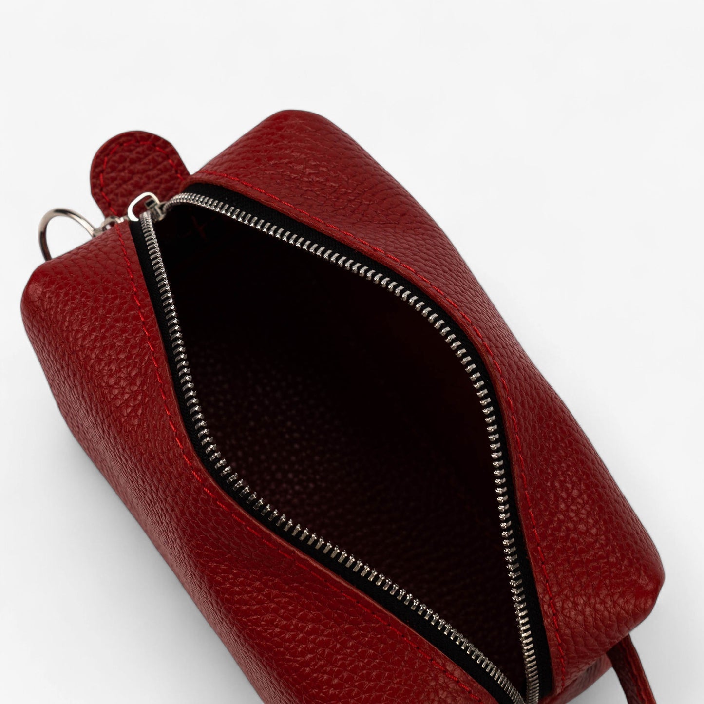 Red leather bag with a zipper on a white background