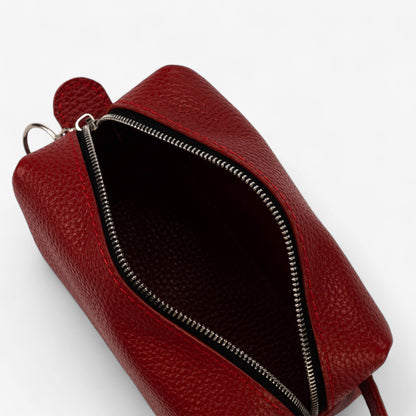 Red leather bag with a zipper on a white background