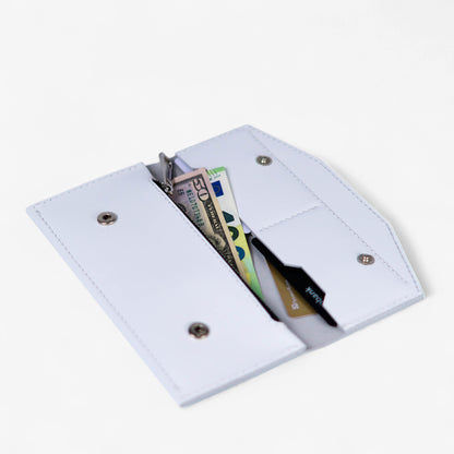 Open white leather wallet filled with cards and cash, compact everyday design