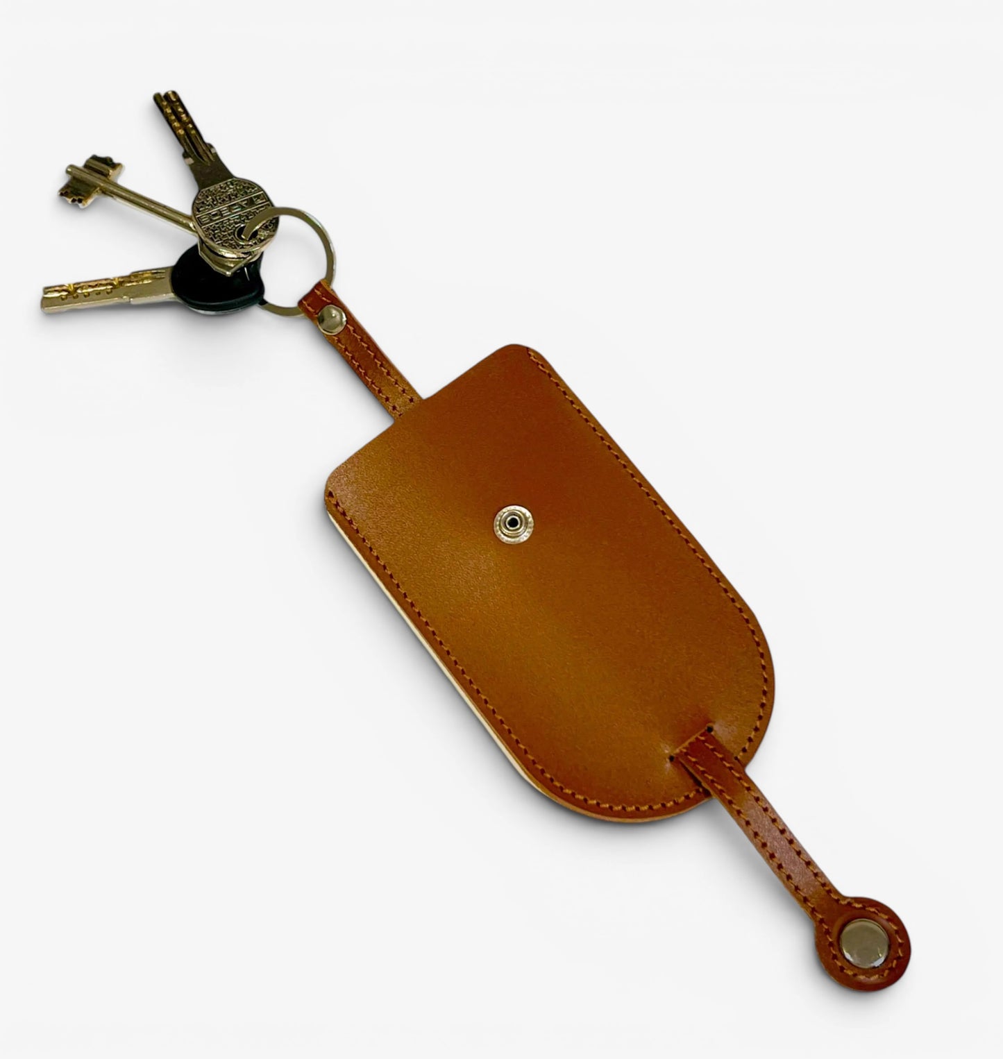 Brown leather key holder with keys on a white background