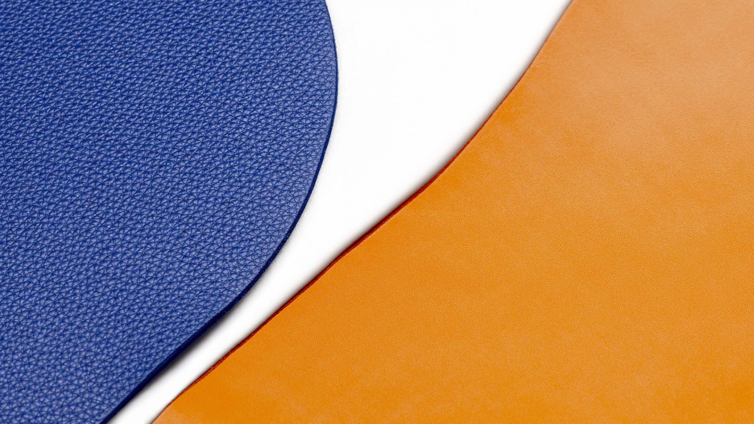 Close-up of two leather types used by Pache: blue pebbled leather and cognac smooth leather
